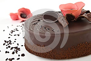 Chocolate cake with white chocolate, cream and peaches on a white background photo